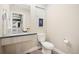 Modern half-bath featuring a stylish vanity, toilet, and decorative wall art at 4469 Tennyson St # 4, Denver, CO 80212