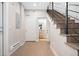 Hallway featuring a staircase, wood floors, and access to a bathroom at 4469 Tennyson St # 4, Denver, CO 80212