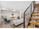 Bright living room featuring modern decor, hardwood floors, and a staircase at 4469 Tennyson St # 4, Denver, CO 80212