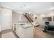 Stylish living area with a large island, modern staircase, and beautiful decor at 4469 Tennyson St # 4, Denver, CO 80212