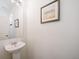 Simple, updated bathroom with pedestal sink and framed artwork at 22052 E 38Th Pl, Aurora, CO 80019