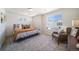 Spacious bedroom with plush bedding, comfortable chair, and large window at 22052 E 38Th Pl, Aurora, CO 80019