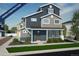 Two-story Craftsman style home with gray and blue siding, a front porch, and landscaping at 22052 E 38Th Pl, Aurora, CO 80019