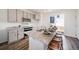 Granite kitchen island with seating, stainless steel appliances, and backyard access at 22052 E 38Th Pl, Aurora, CO 80019