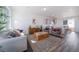 Spacious living room with hardwood floors, large windows and stylish furniture at 22052 E 38Th Pl, Aurora, CO 80019