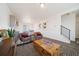Living room with hardwood floors, large windows, and a statement wooden coffee table at 22052 E 38Th Pl, Aurora, CO 80019