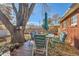 Deck with table and chairs, overlooking a large backyard at 9676 Rensselaer Dr, Arvada, CO 80004