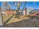 Spacious backyard with deck, raised garden beds, and mature trees at 9676 Rensselaer Dr, Arvada, CO 80004