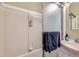 Small bathroom with shower/tub combo and a small vanity at 9676 Rensselaer Dr, Arvada, CO 80004