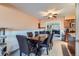 Bright dining room with wood table and chairs, adjacent to kitchen at 9676 Rensselaer Dr, Arvada, CO 80004