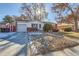 Ranch style home with attached garage and landscaped yard at 9676 Rensselaer Dr, Arvada, CO 80004