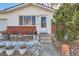 House entrance with brick facade, steps, and potted plants at 9676 Rensselaer Dr, Arvada, CO 80004