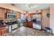 Modern kitchen featuring stainless steel appliances and granite island at 9676 Rensselaer Dr, Arvada, CO 80004