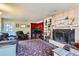 Living room featuring a fireplace and built-in shelving at 9676 Rensselaer Dr, Arvada, CO 80004