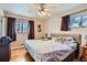 Main bedroom with ceiling fan and ample closet space at 9676 Rensselaer Dr, Arvada, CO 80004