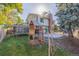 Large backyard with playset, trampoline, and patio at 1661 Red Fox Pl, Highlands Ranch, CO 80126