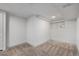 Empty, carpeted basement room with overhead lighting at 1661 Red Fox Pl, Highlands Ranch, CO 80126