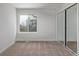 Well-lit bedroom featuring carpet, window, and mirrored closet at 1661 Red Fox Pl, Highlands Ranch, CO 80126