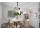 Bright dining area with white table and four chairs, adjacent to kitchen at 1661 Red Fox Pl, Highlands Ranch, CO 80126