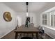 Modern dining room with wood table and statement art at 1661 Red Fox Pl, Highlands Ranch, CO 80126