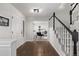 Bright entryway with hardwood floors, leading to office and staircase at 1661 Red Fox Pl, Highlands Ranch, CO 80126