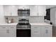 Modern kitchen with stainless steel appliances and white cabinetry at 1661 Red Fox Pl, Highlands Ranch, CO 80126