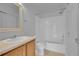 Cozy bathroom featuring a shower-tub combo, sink, and framed mirror at 3590 S Malaya St, Aurora, CO 80013