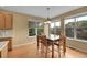 Bright dining area featuring wood floors and large windows for abundant natural light at 3590 S Malaya St, Aurora, CO 80013