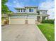 Charming two-story home boasts a well-manicured lawn and a convenient two-car garage at 3590 S Malaya St, Aurora, CO 80013