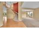 Grand foyer with a curved staircase and views into the living spaces at 3590 S Malaya St, Aurora, CO 80013