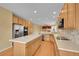 Spacious kitchen with light wood cabinets, island, and stainless steel appliances at 3590 S Malaya St, Aurora, CO 80013
