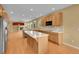 Kitchen featuring an island and stainless steel appliances seamlessly open to living area at 3590 S Malaya St, Aurora, CO 80013