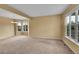 Bright living room with large windows and neutral carpet at 3590 S Malaya St, Aurora, CO 80013