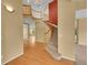 Bright entryway with hardwood floors and a curved staircase with wood railing at 3590 S Malaya St, Aurora, CO 80013