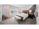 A stylish bedroom with large windows for natural light, decorative wall accents, and modern furniture at 17152 W 91St Ln, Arvada, CO 80007