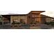 Clubhouse with covered seating, large windows, and landscaped entryway at 17152 W 91St Ln, Arvada, CO 80007