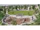 View of the community park with playground, picnic shelter, walking path, and open green space at 17152 W 91St Ln, Arvada, CO 80007