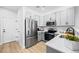 Well-lit kitchen featuring stainless steel appliances, gray cabinetry, and white countertops at 17152 W 91St Ln, Arvada, CO 80007