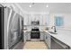 Contemporary kitchen featuring stainless steel appliances, gray cabinets, and white countertops at 17152 W 91St Ln, Arvada, CO 80007