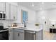 Modern kitchen featuring stainless steel appliances, gray cabinets, and subway tile backsplash at 17152 W 91St Ln, Arvada, CO 80007