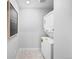 Functional laundry room with stacked washer and dryer and tiled flooring at 17152 W 91St Ln, Arvada, CO 80007