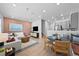 Open-concept living room and kitchen with a stylish pink accent wall and modern decor at 17152 W 91St Ln, Arvada, CO 80007