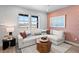 Cozy living room featuring large windows with views, a sectional sofa, and stylish decor at 17152 W 91St Ln, Arvada, CO 80007