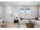 Inviting living room with large windows offering a view and a comfortable white sectional sofa at 17152 W 91St Ln, Arvada, CO 80007