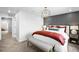 Spacious primary bedroom with a decorative wall, chandelier, and an inviting bench at 17152 W 91St Ln, Arvada, CO 80007