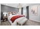 Beautiful primary bedroom with decorative wall paneling, chandelier, and bench at 17152 W 91St Ln, Arvada, CO 80007