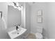 Stylish powder room with modern fixtures, floating vanity, and toilet at 17152 W 91St Ln, Arvada, CO 80007