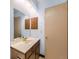 Bathroom featuring a single sink vanity, large mirror, and neutral paint at 8236 Washington St # 29, Denver, CO 80229