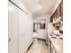 Galley kitchen view showcasing storage and an open concept through to living area at 8236 Washington St # 29, Denver, CO 80229