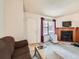 Spacious living room with fireplace and bright windows, ideal for gatherings at 8236 Washington St # 29, Denver, CO 80229